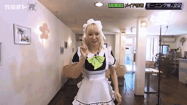 a woman in a maid outfit is standing in a room with a sign that says 122