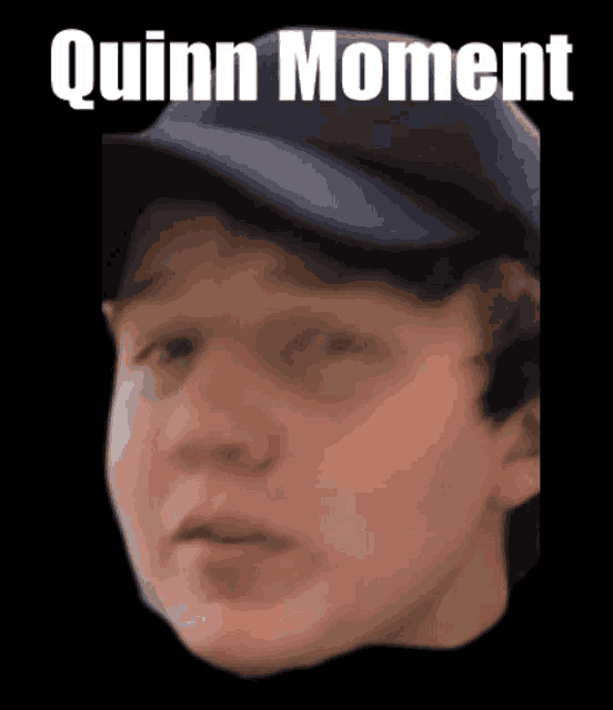 a close up of a person 's face with the words quinn moment above him