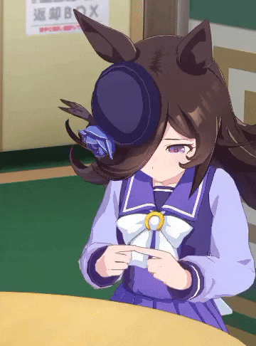 a girl wearing a blue hat is sitting at a table with a sign in the background that says box