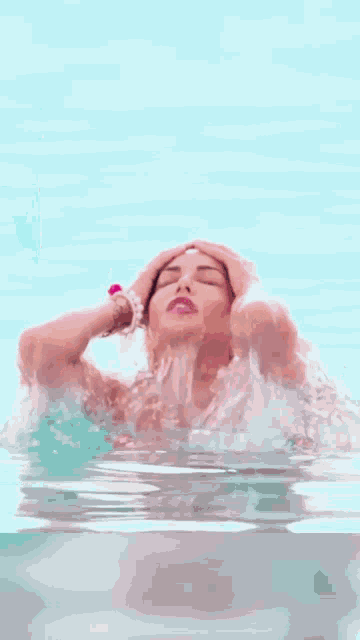 a woman in a pink bikini is posing for a picture