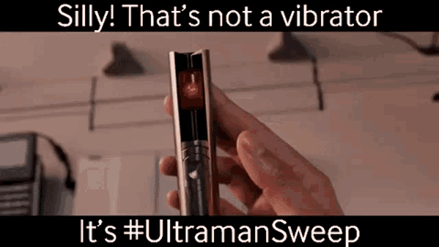 a person is holding a device that is not a vibrator .