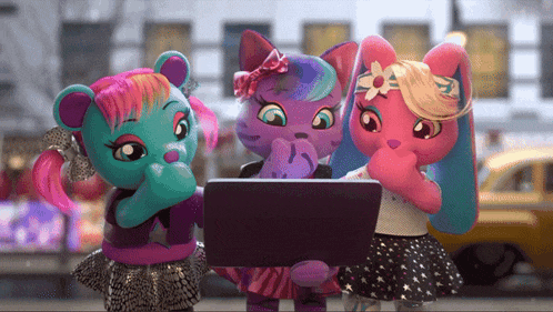 three stuffed animals looking at a laptop together