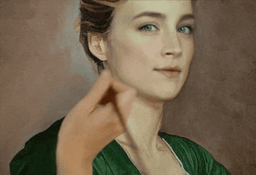 a close up of a woman 's face with a hand pointing at it