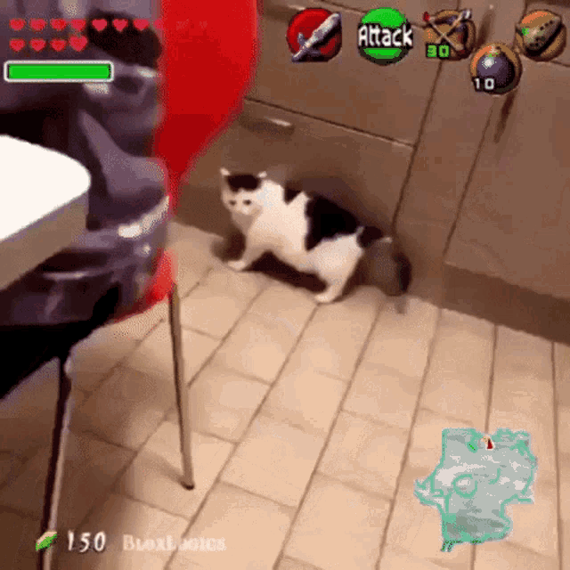 a black and white cat is playing a video game with the attack button visible
