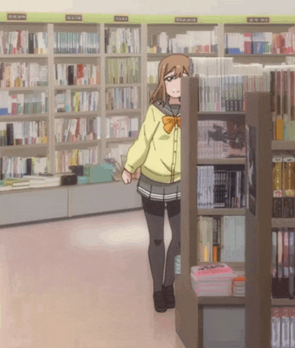 a girl in a yellow jacket stands in front of a bookshelf with a sign that says ' a ' on it