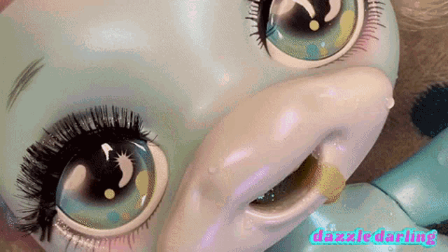a close up of a doll with the words dazzle darling on the bottom right