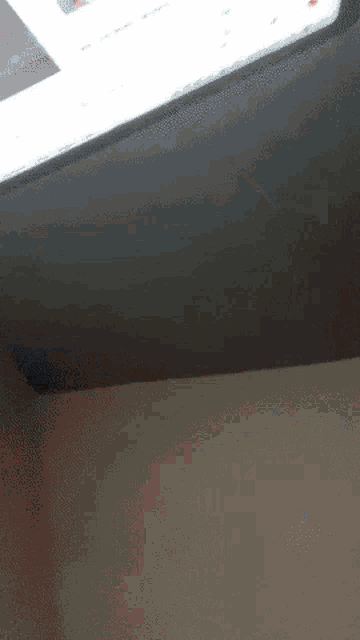 a ceiling with a light on it and a white wall