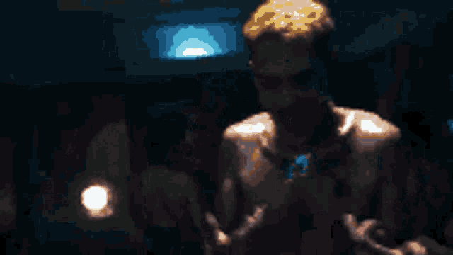 a pixel art of a shirtless man in a dark room .