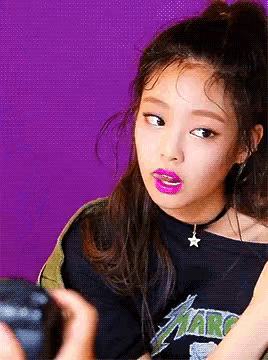 a young girl wearing a black shirt that says atari