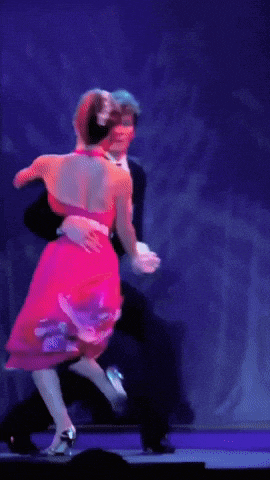 a man and a woman are dancing on a stage