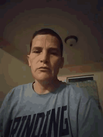 a man wearing a t-shirt that says ' nc ' on it
