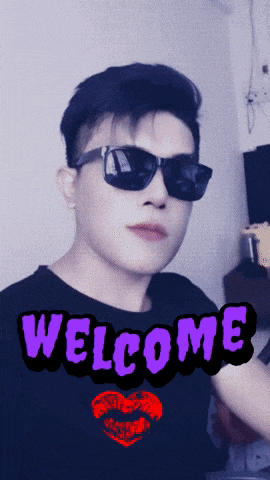 a man wearing sunglasses and a shirt that says welcome on it