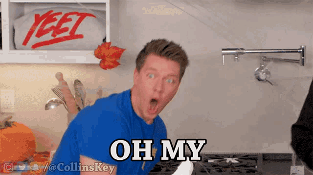 a man in a blue shirt says " oh my " in a kitchen