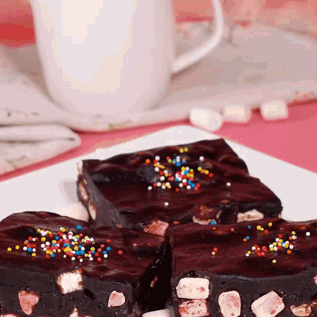 a white plate topped with chocolate brownies with sprinkles