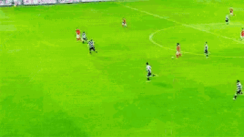 a group of soccer players are playing a game on a green field