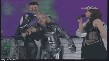 a group of people dancing on a stage with the word show behind them