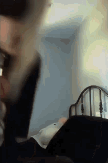 a blurry picture of a person laying on a bed .