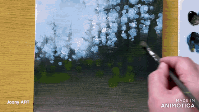 a person is painting a picture with the words made in animatica visible