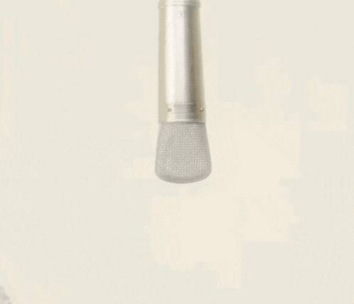 a woman in a white fur coat holds a microphone in her hand
