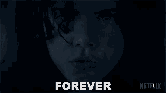 a close up of a person 's face in the dark with the words `` forever '' written above it .