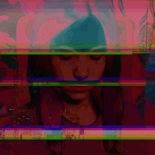 a woman 's face is partially obscured by a rainbow colored striped background