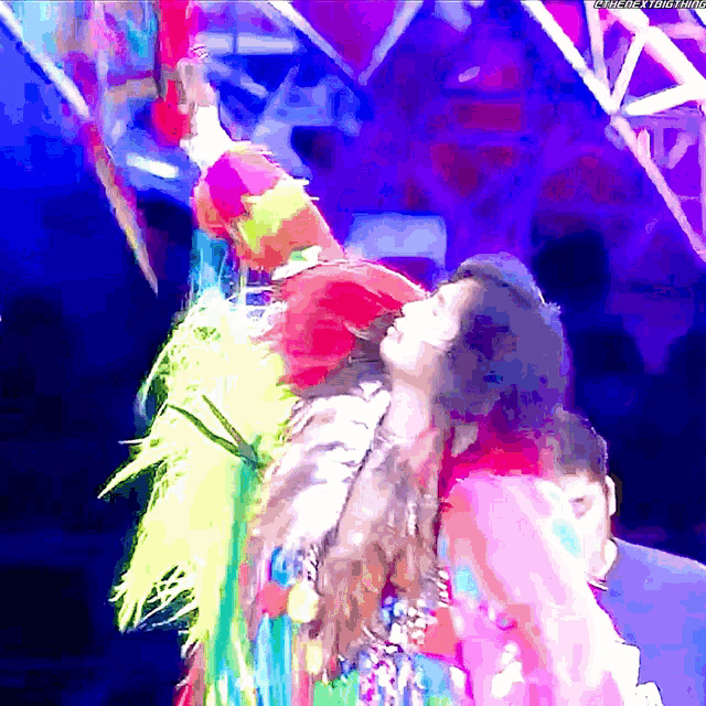 a woman in a colorful costume is dancing in front of a purple background with the words " fuck the timeframe " visible