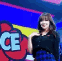 a woman stands in front of a sign that says ce