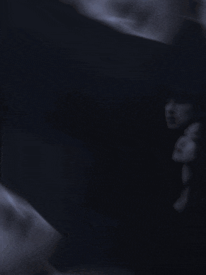 a man and a woman looking at each other with hearts around them