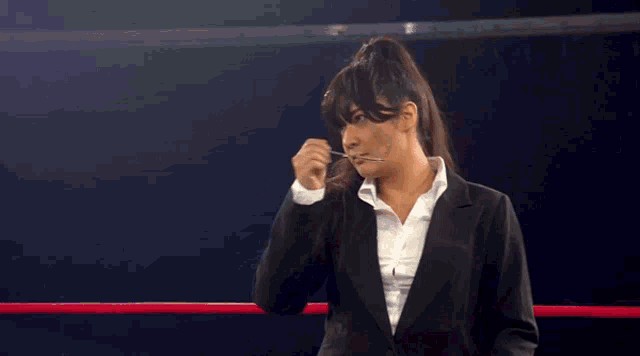 a woman in a wrestling ring with a sign that says improve