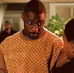 a man with glasses and a beard is talking to another man .