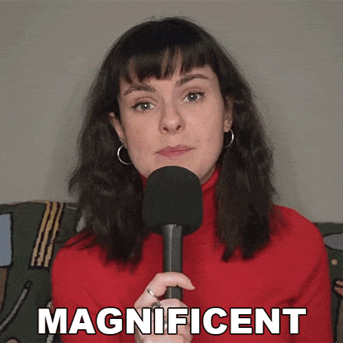 a woman in a red sweater is holding a microphone and the word magnificent is above her head