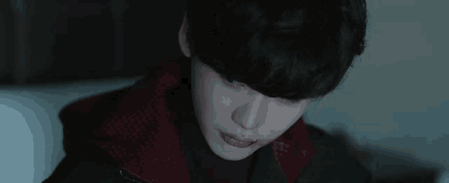 a close up of a person 's face with a black jacket on