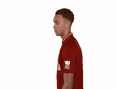 a soccer player wearing a red shirt that says standard chartered on it