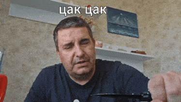 a man in a black shirt is holding a pair of scissors with a caption that says ' chaka chaka '
