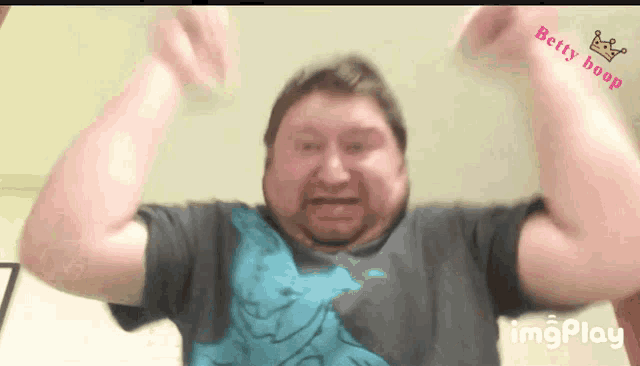a man with his arms in the air with the words betty hoop on the bottom
