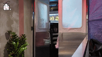 a stainless steel door with a plant in front of it and a sign that says ' a ' on it .
