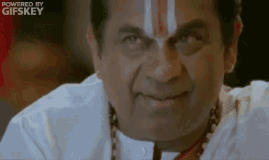 a close up of a man with a red and white stripe on his forehead .