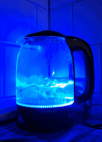 a glass kettle with a blue light on the inside of it