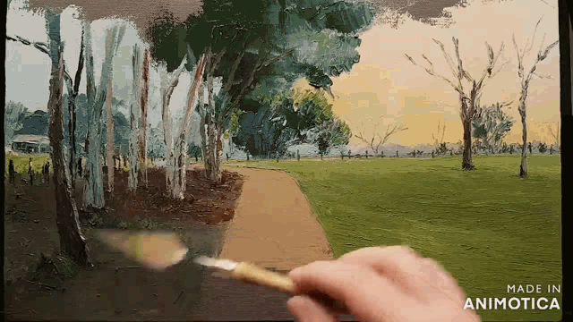 a person is painting a path in a park with the words made in animotica in the corner