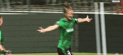 a woman wearing a green jersey with the number 7 on it