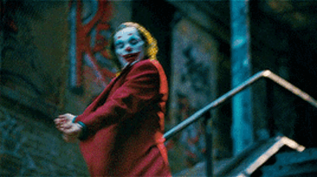 a man in a clown costume is standing on stairs
