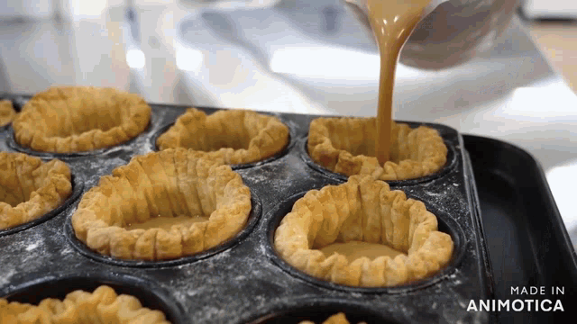a person is pouring liquid into a muffin tin that says made in animonica