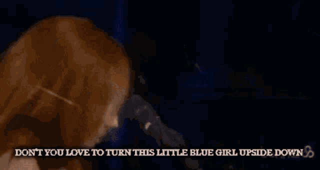 a woman singing into a microphone with the words do n't you love to turn this little blue girl upside down below her