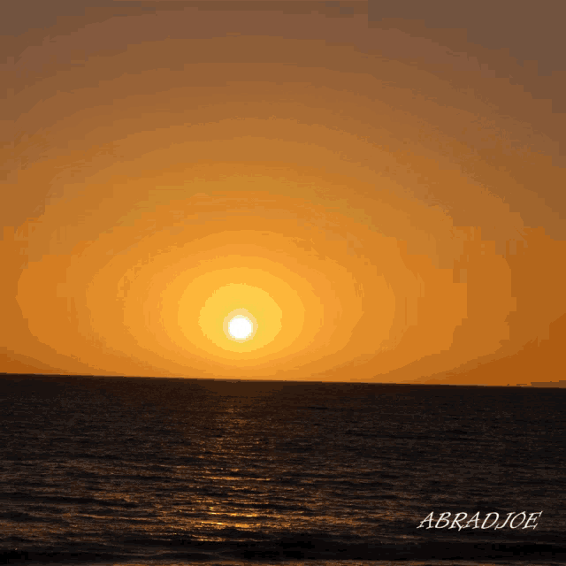 a picture of a sunset over the ocean taken by abradjee