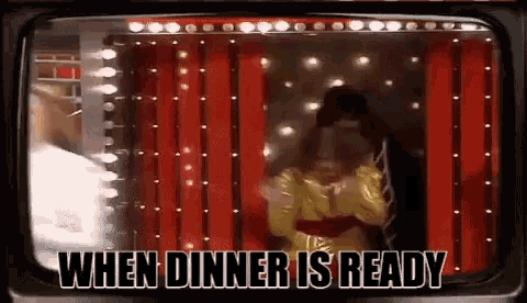 a woman is standing in front of a red curtain on a television screen with the words when dinner is ready .