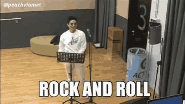 a woman singing into a microphone with the words rock and roll written below her