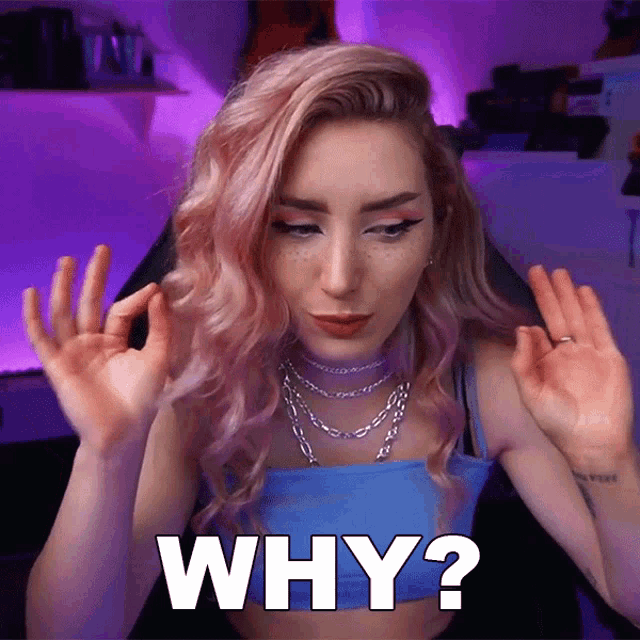 a woman with pink hair says why in white
