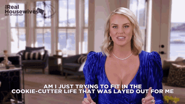 a woman in a blue dress is talking about a cookie cutter life