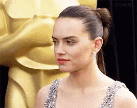 a close up of a woman 's face with a ponytail and red lipstick .