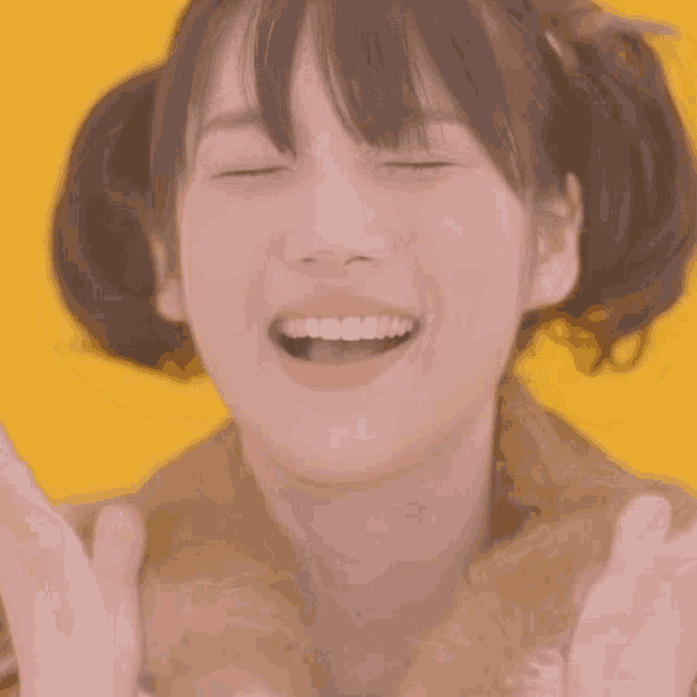 a close up of a girl 's face with her eyes closed